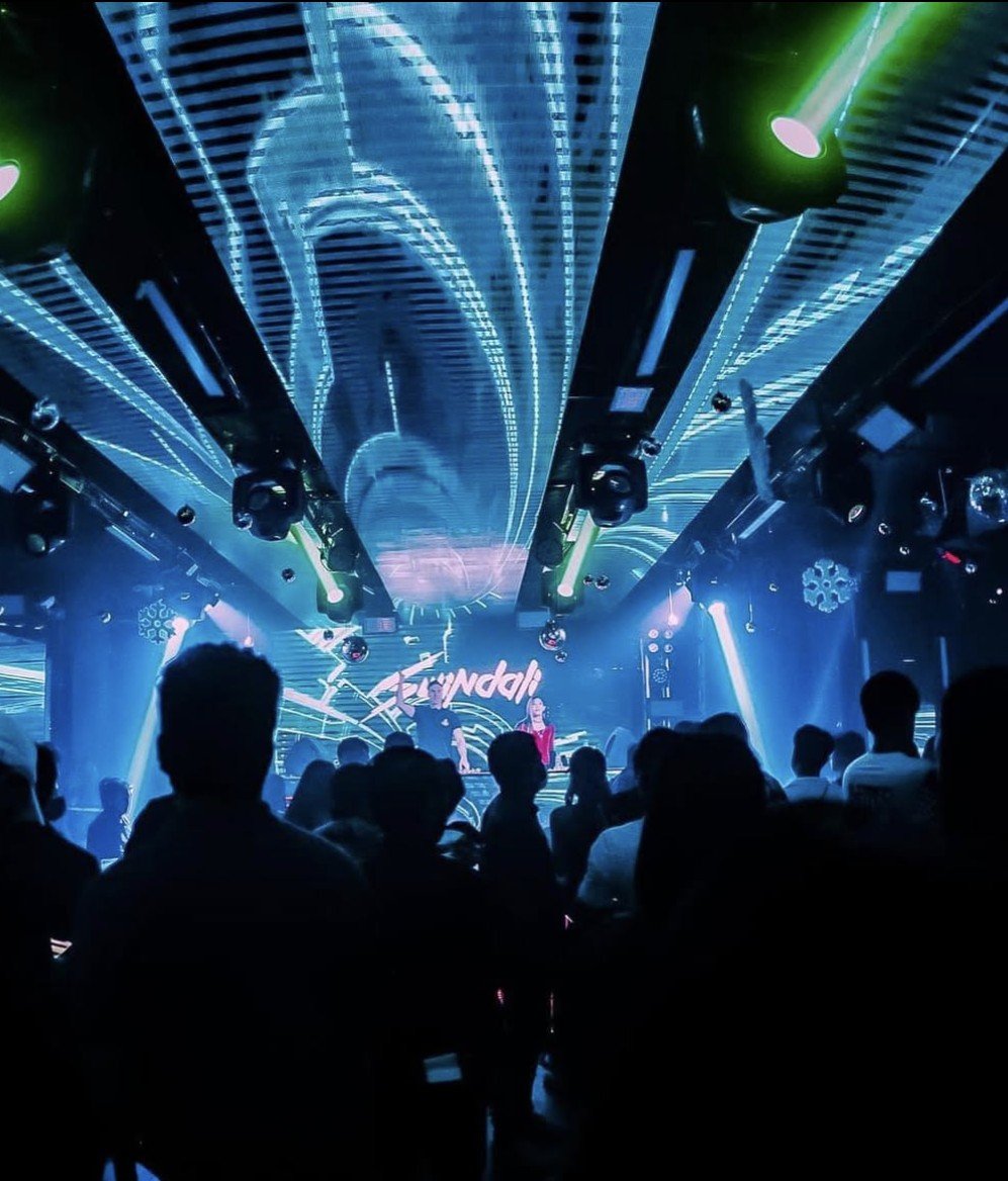 Swindali performing in a blue-lit club