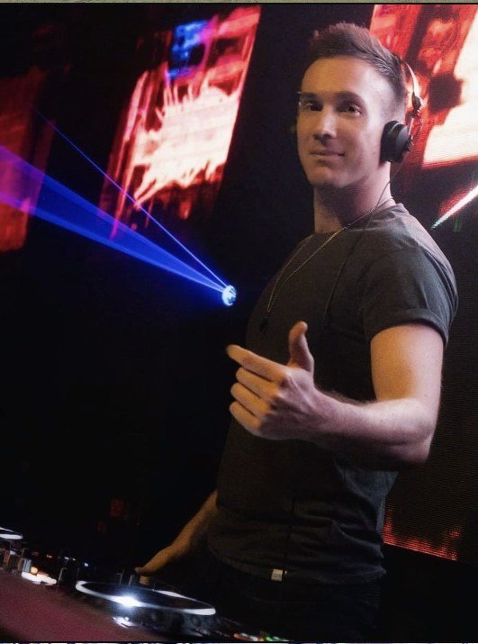 Swindali at the DJ booth with lasers